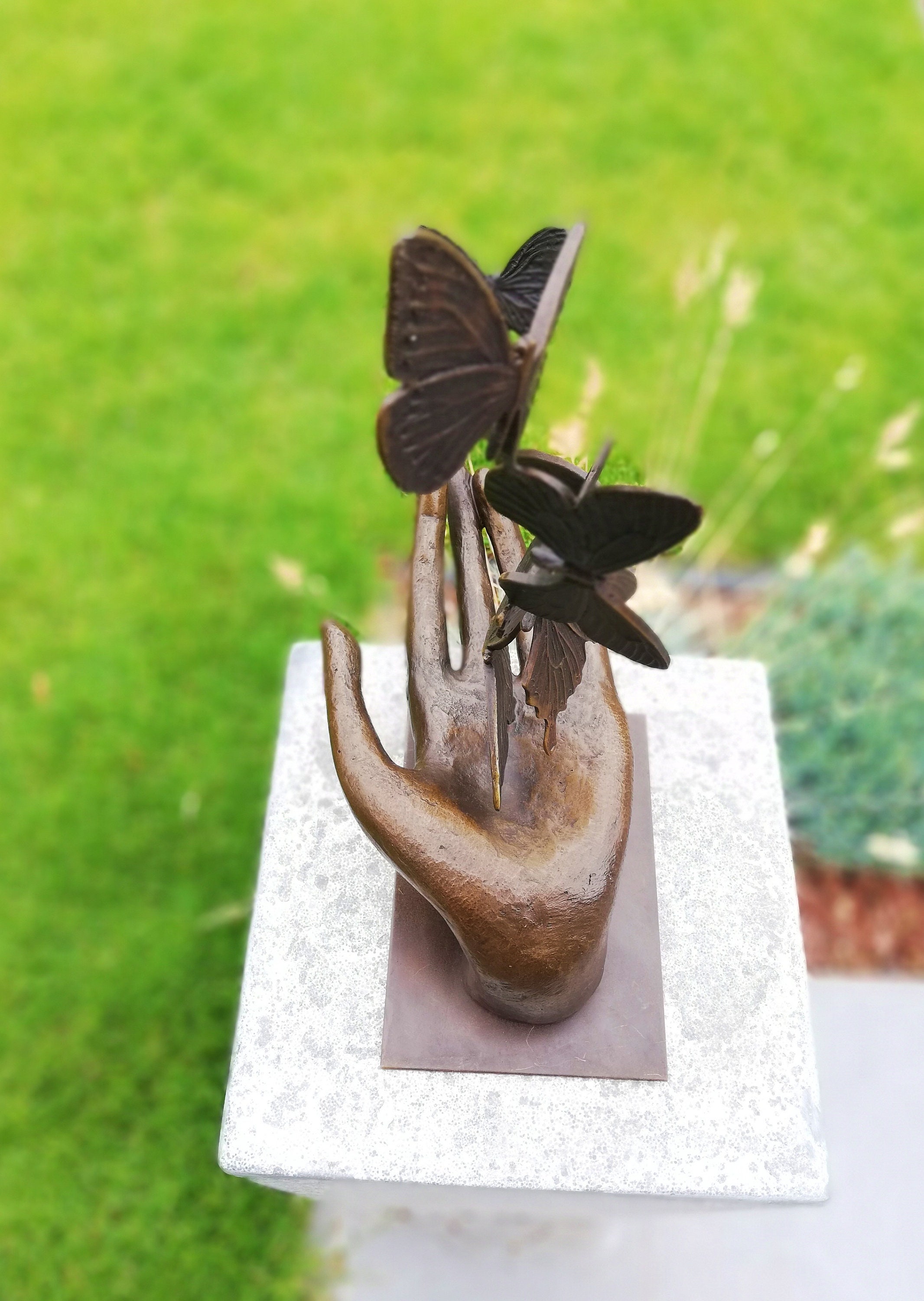 Bronze sculpture releasing butterflies