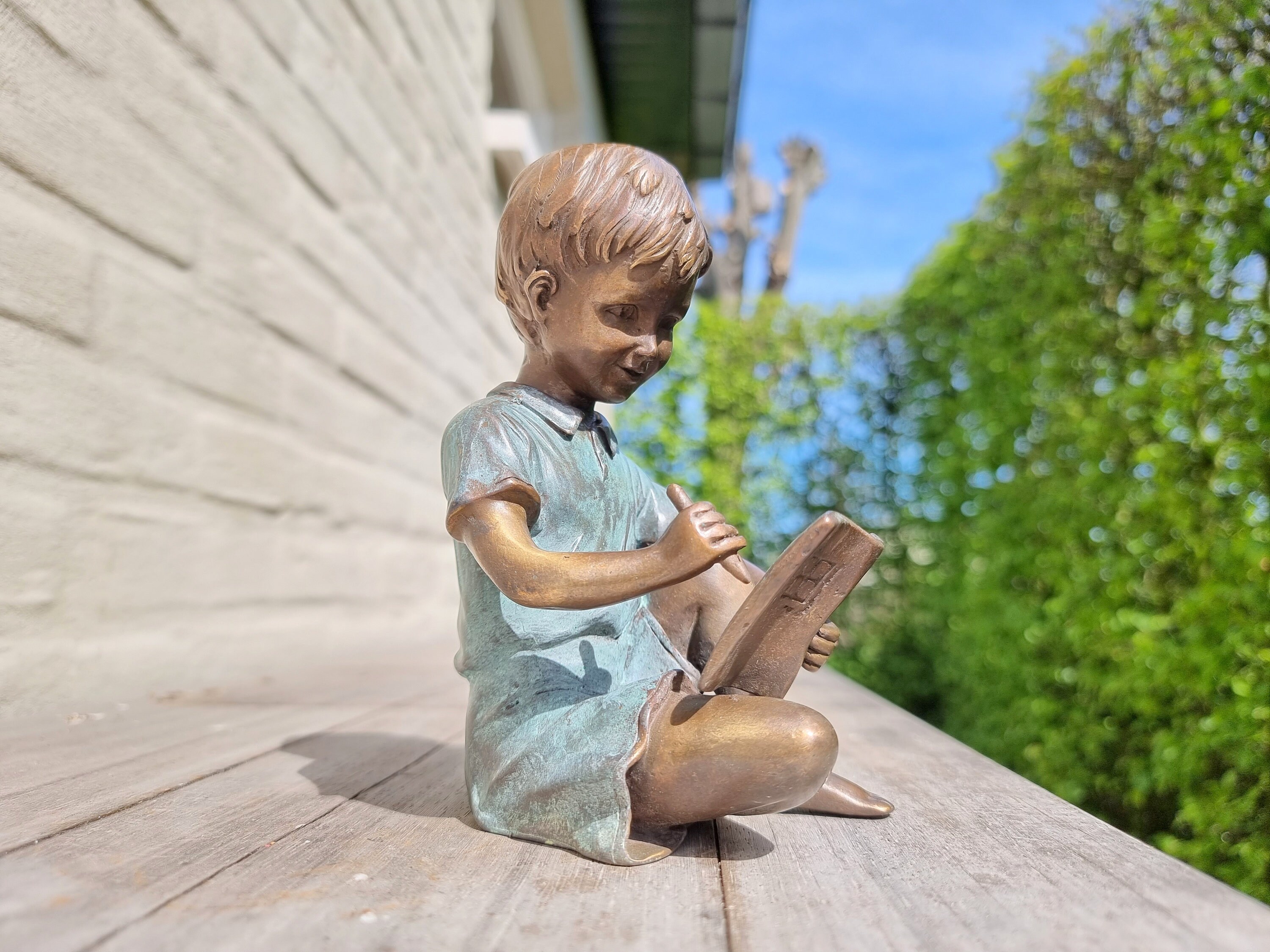Bronze sculpture of a boy reading a book Bronze garden ornaments