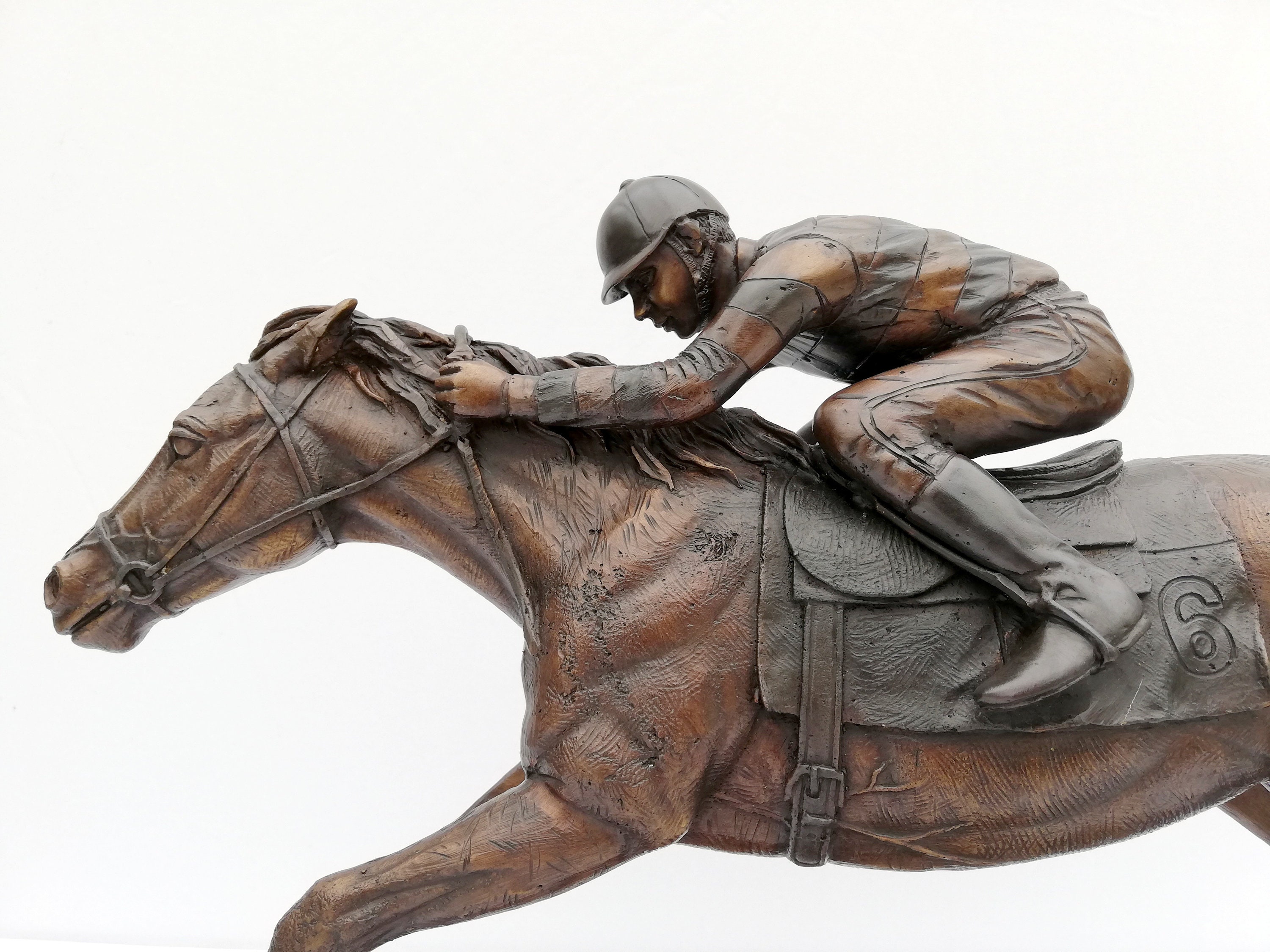Bronze sculpture of a jockey on his racing horse