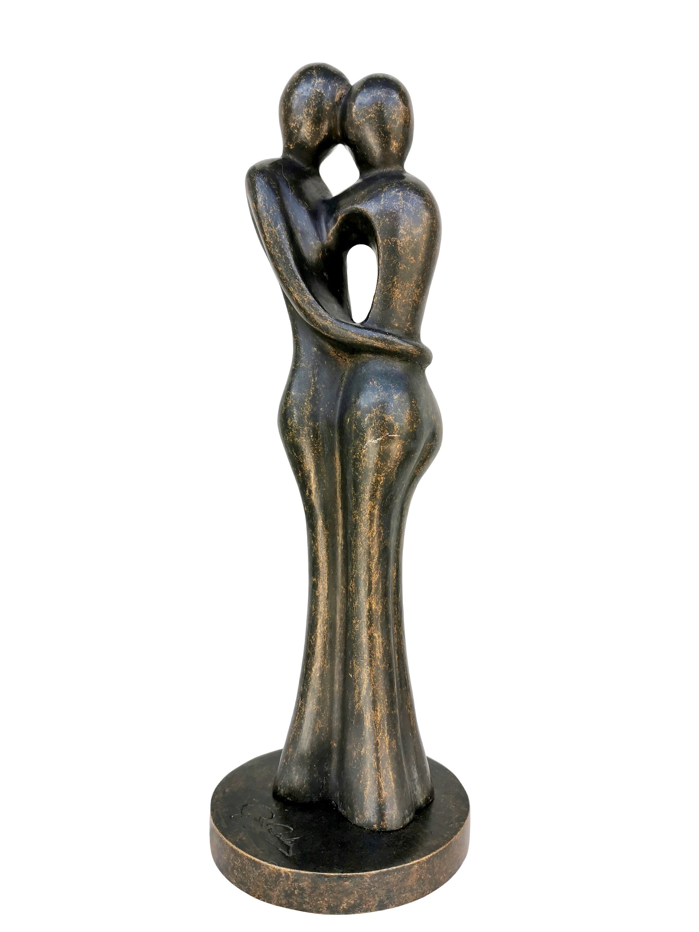 A bronze sculpture of a loving couple