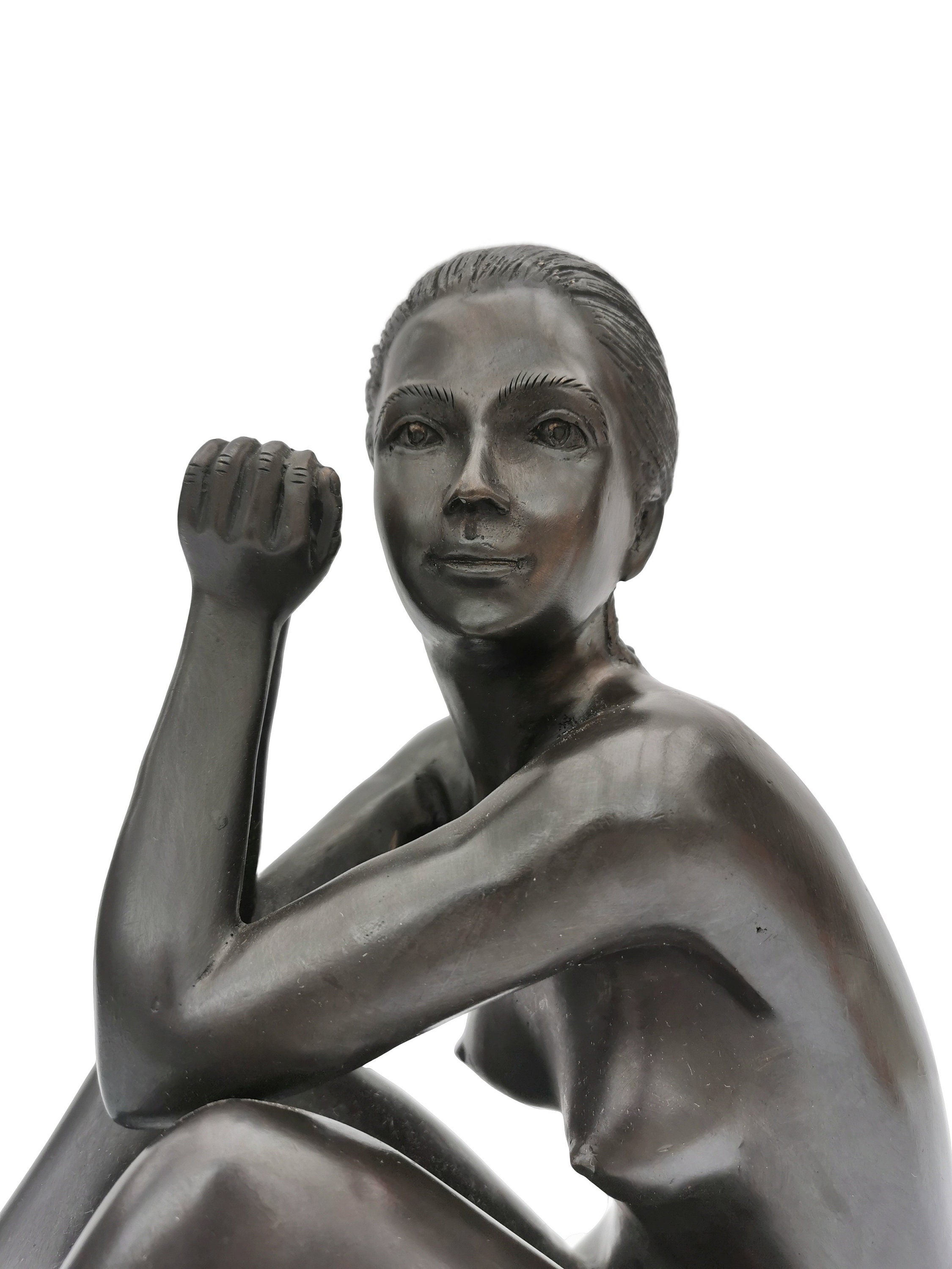 Bronze sculpture of a sitting woman
