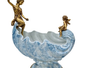 Shell shaped porcelain bowl on waves with bronze ornaments