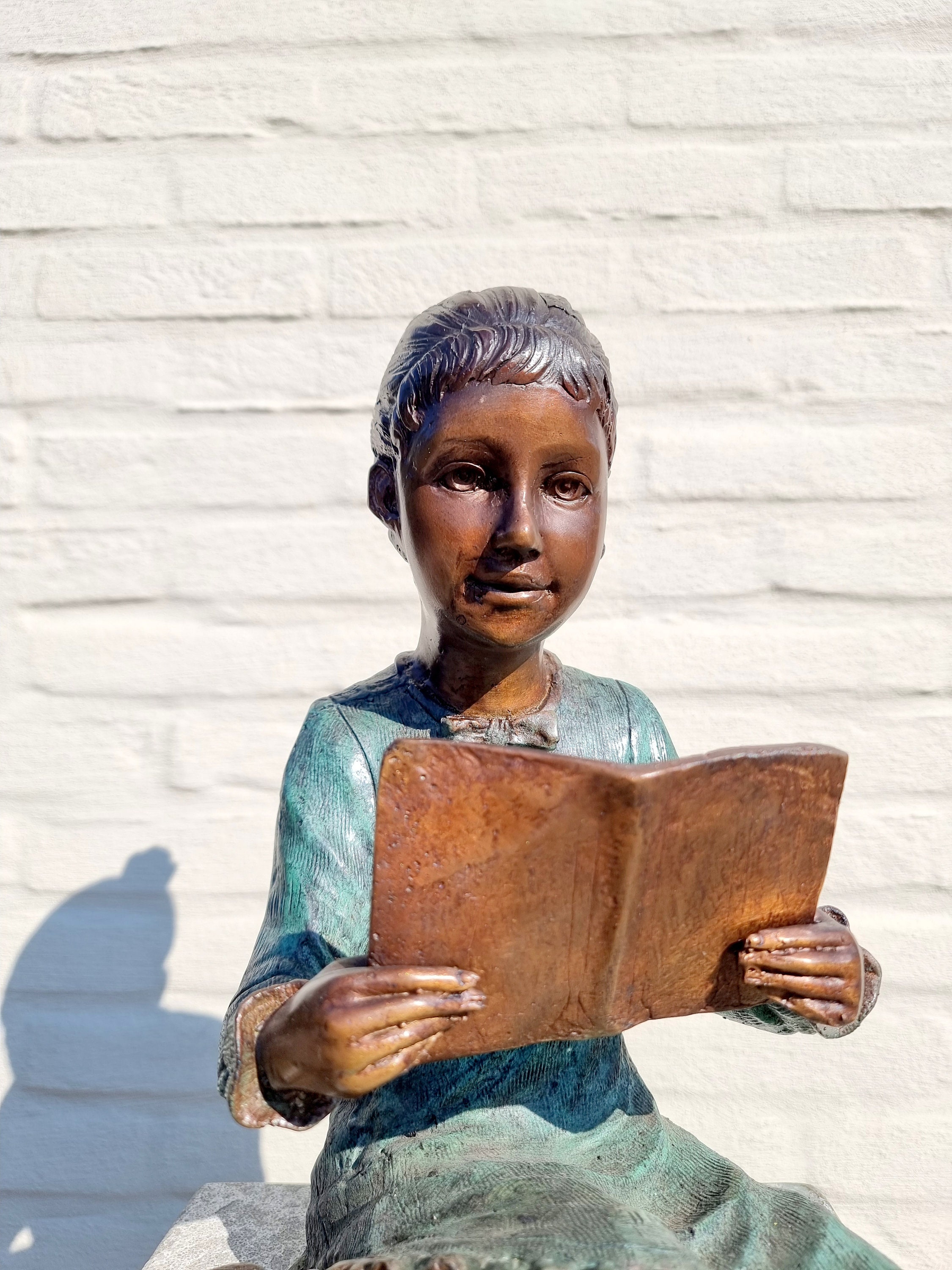 Bronze sculpture of a girl reading a book Bronze garden sculptures