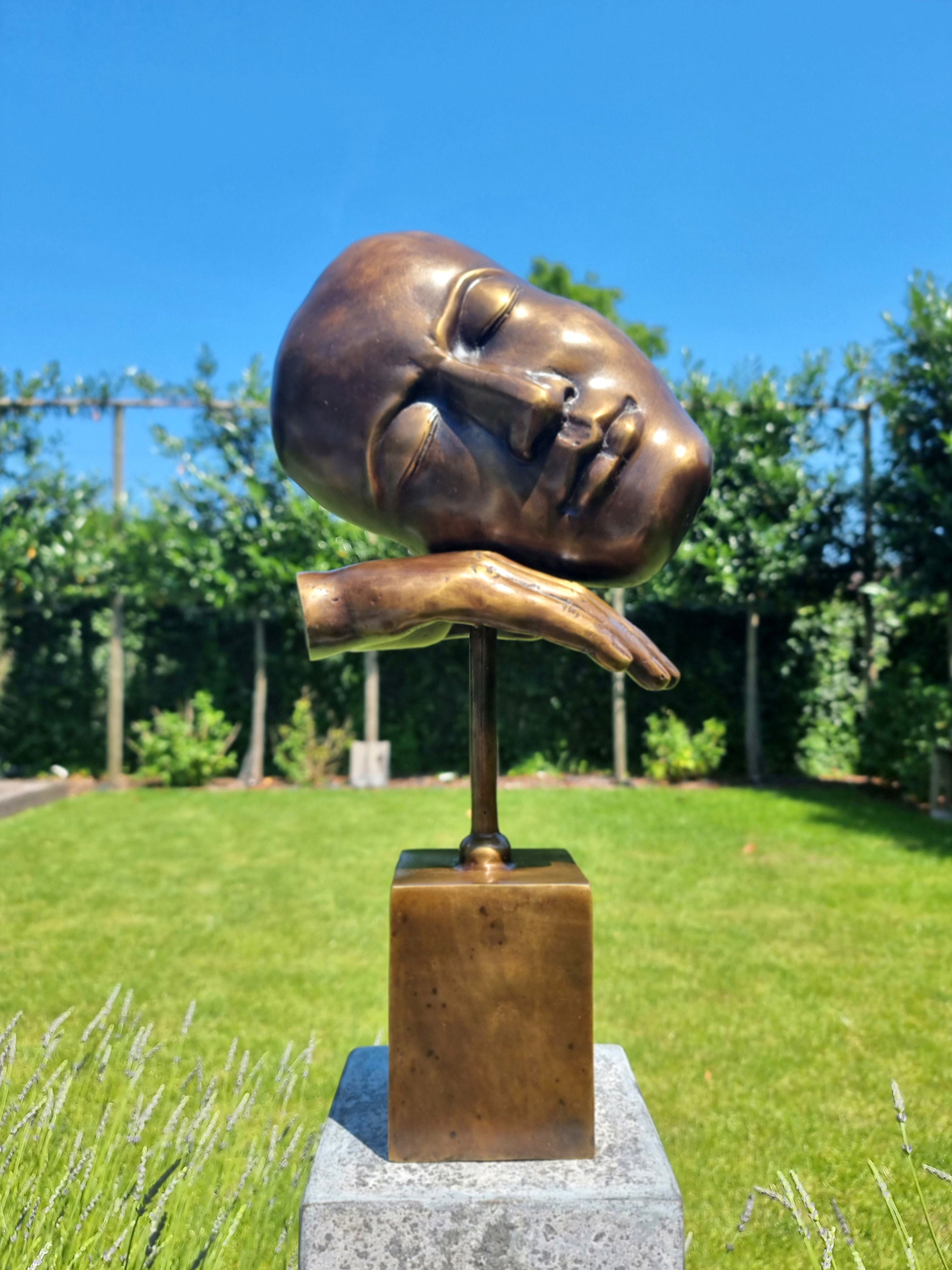 Bronze sculpture of a face with hand Abstract and contemporary bronze