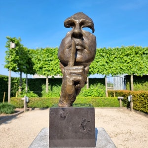 Garden sculpture of a man who asks for silence - The whispering man - Bronze whispering man