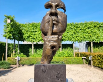 Garden sculpture of a man who asks for silence - The whispering man - Bronze whispering man