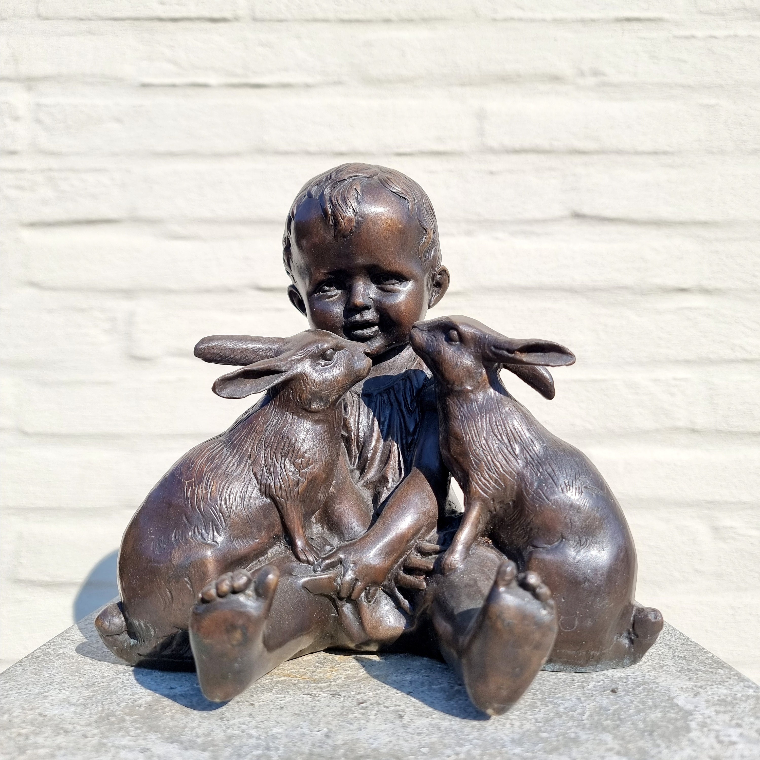 Bronze toddler plays with rabbits Bronze sculpture Easter decoration