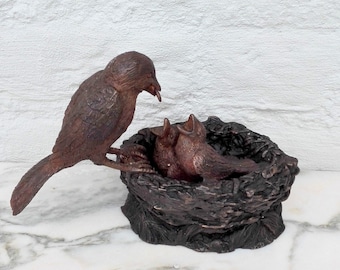 A bronze statuette of a bird’s nest