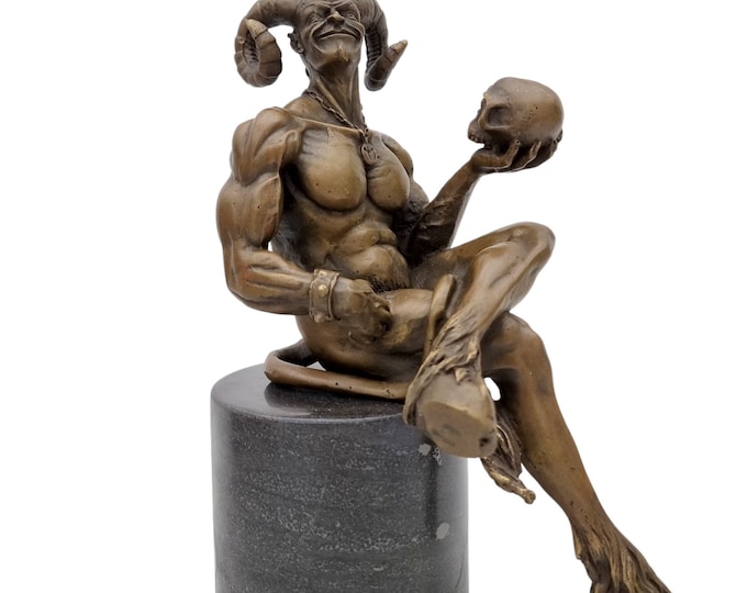 Bronze sculpture of a demon holding a skull