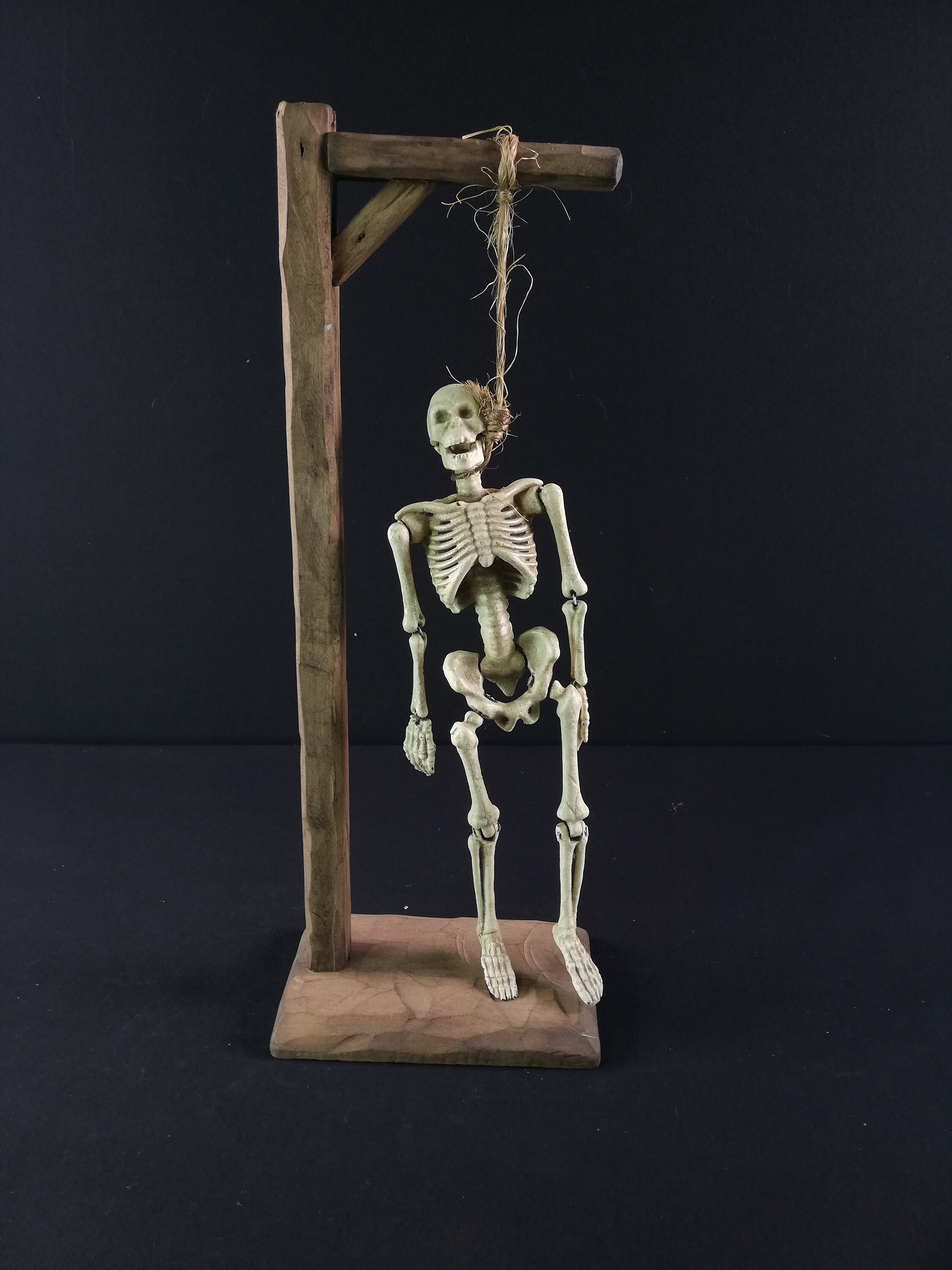 Iron skeleton hanging on a wooden gallows