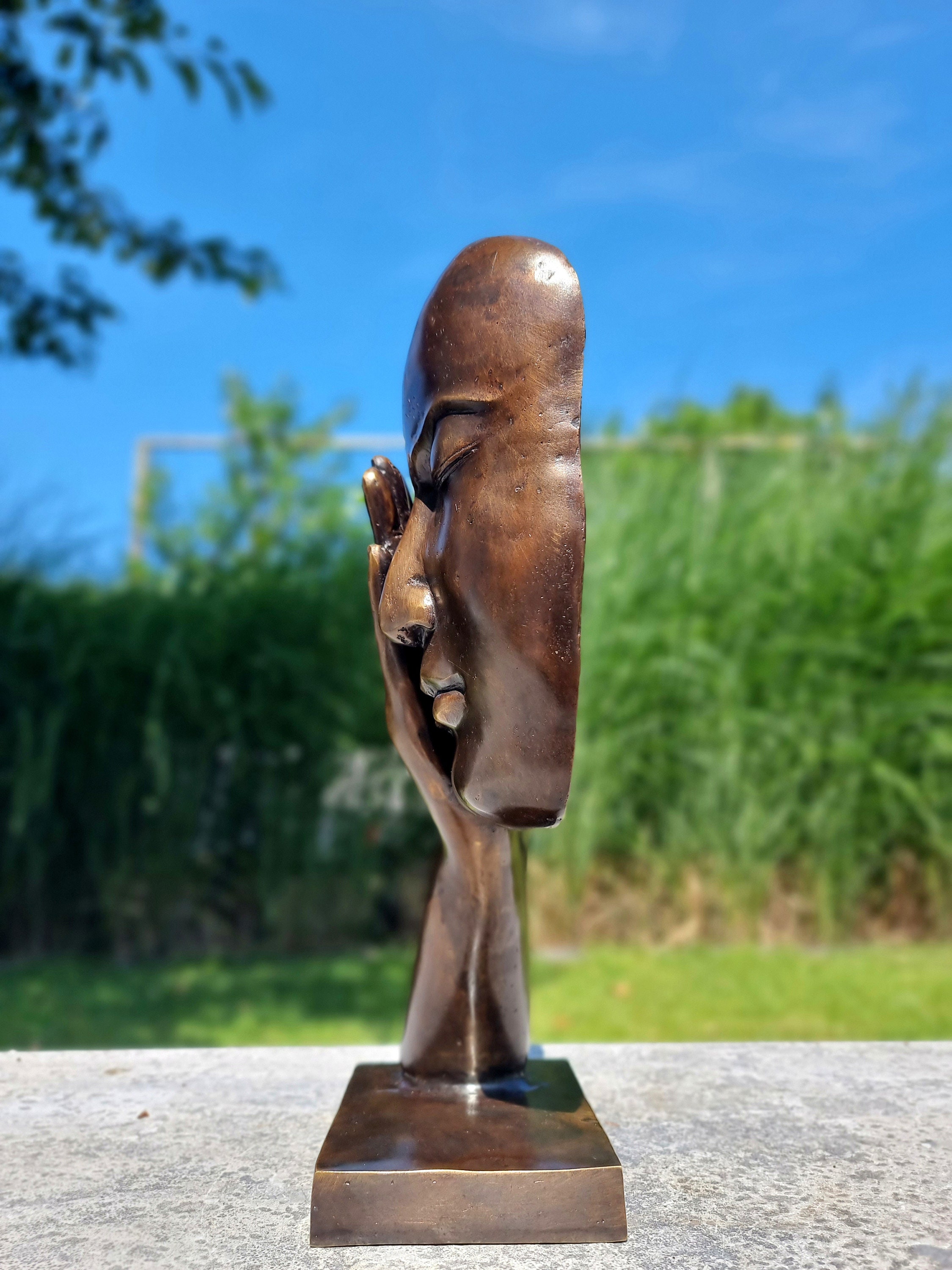 Bronze sculpture of a face with hand Abstract and contemporary bronze