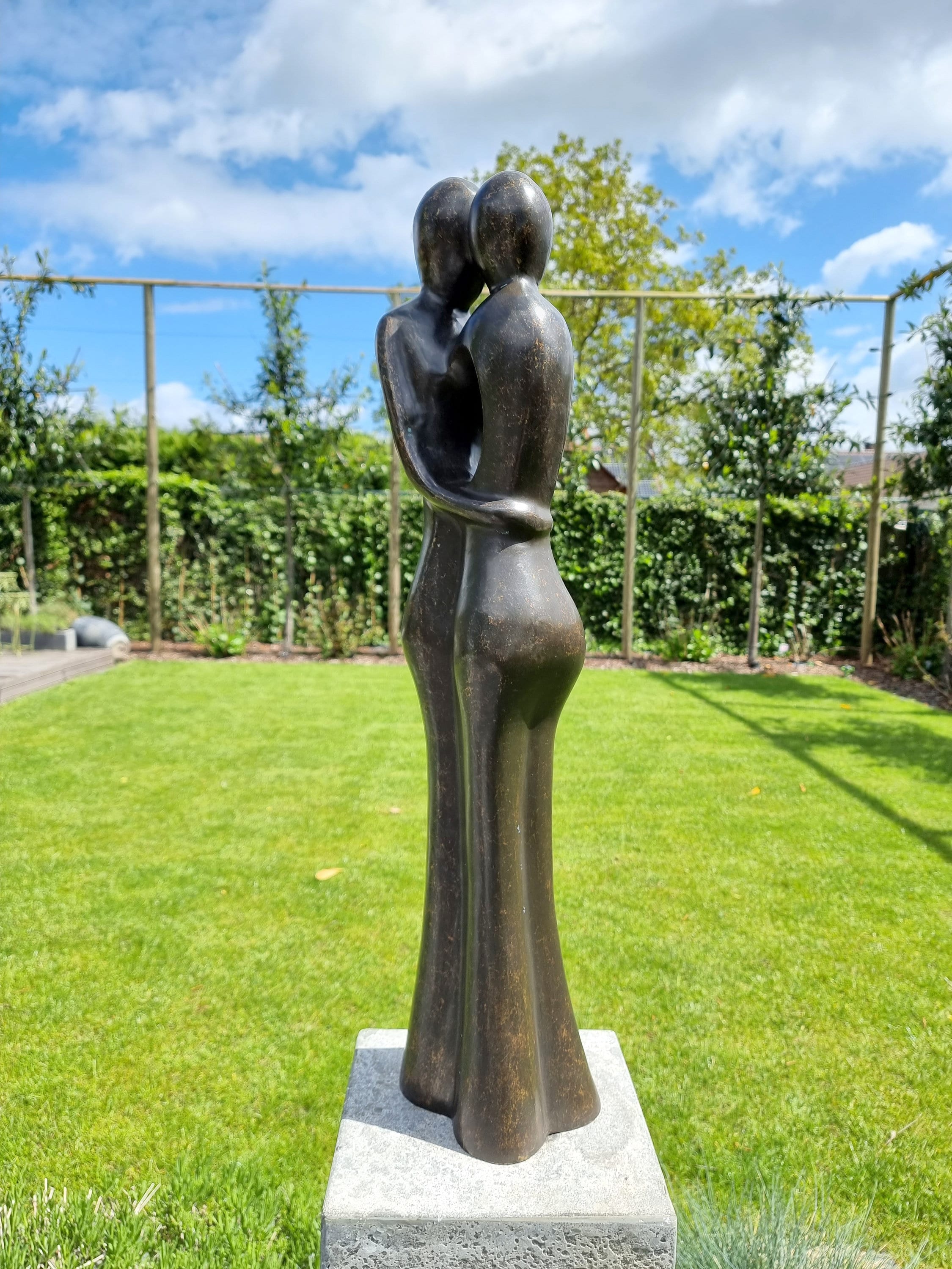 Bronze garden sculpture of an embracing couple Abstract and modern