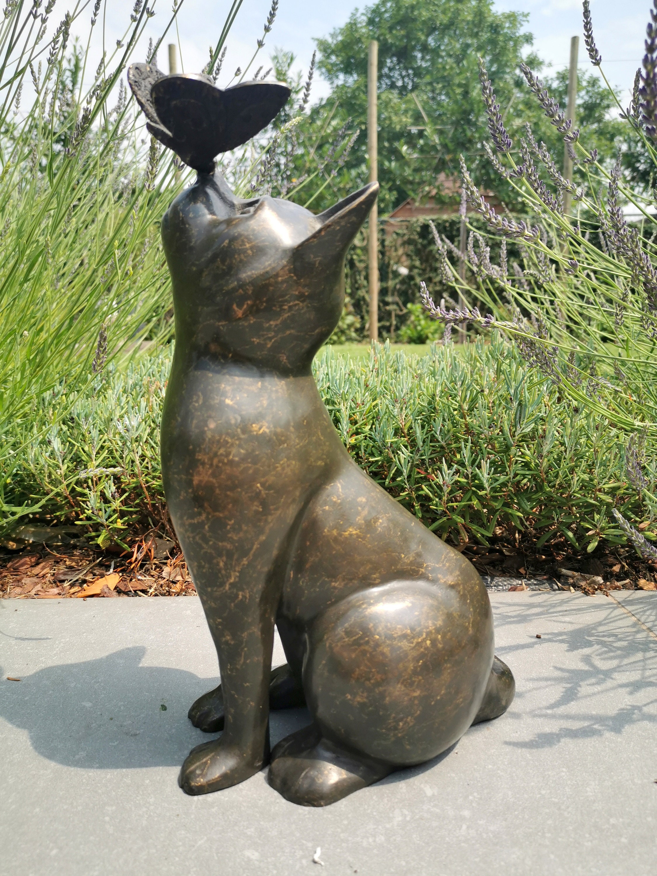 Beautiful bronze sculpture of a cat with a butterfly on it's nose