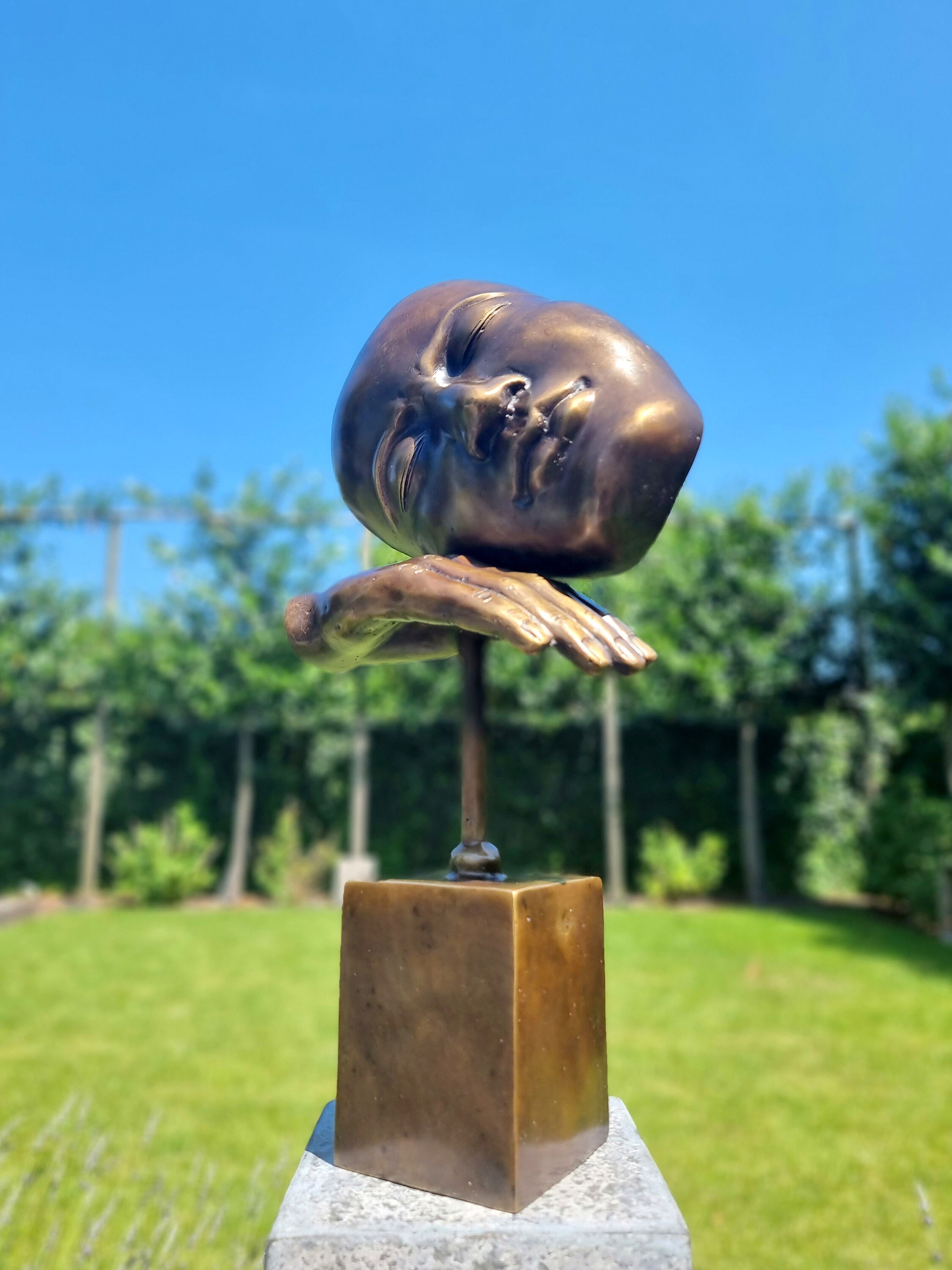 Bronze sculpture of a face with hand Abstract and contemporary bronze