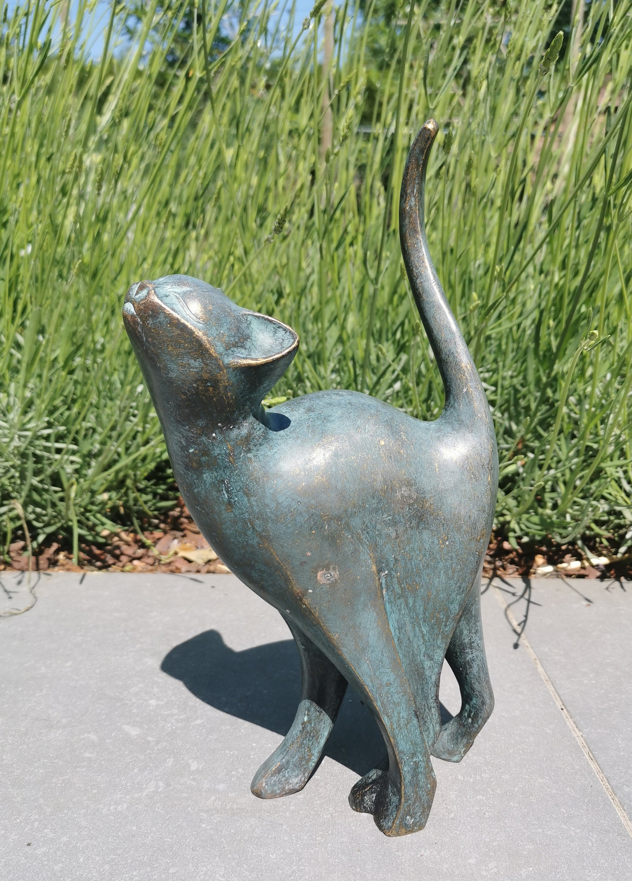 Beautiful bronze sculpture of a cat with a rounded back Bronze garden