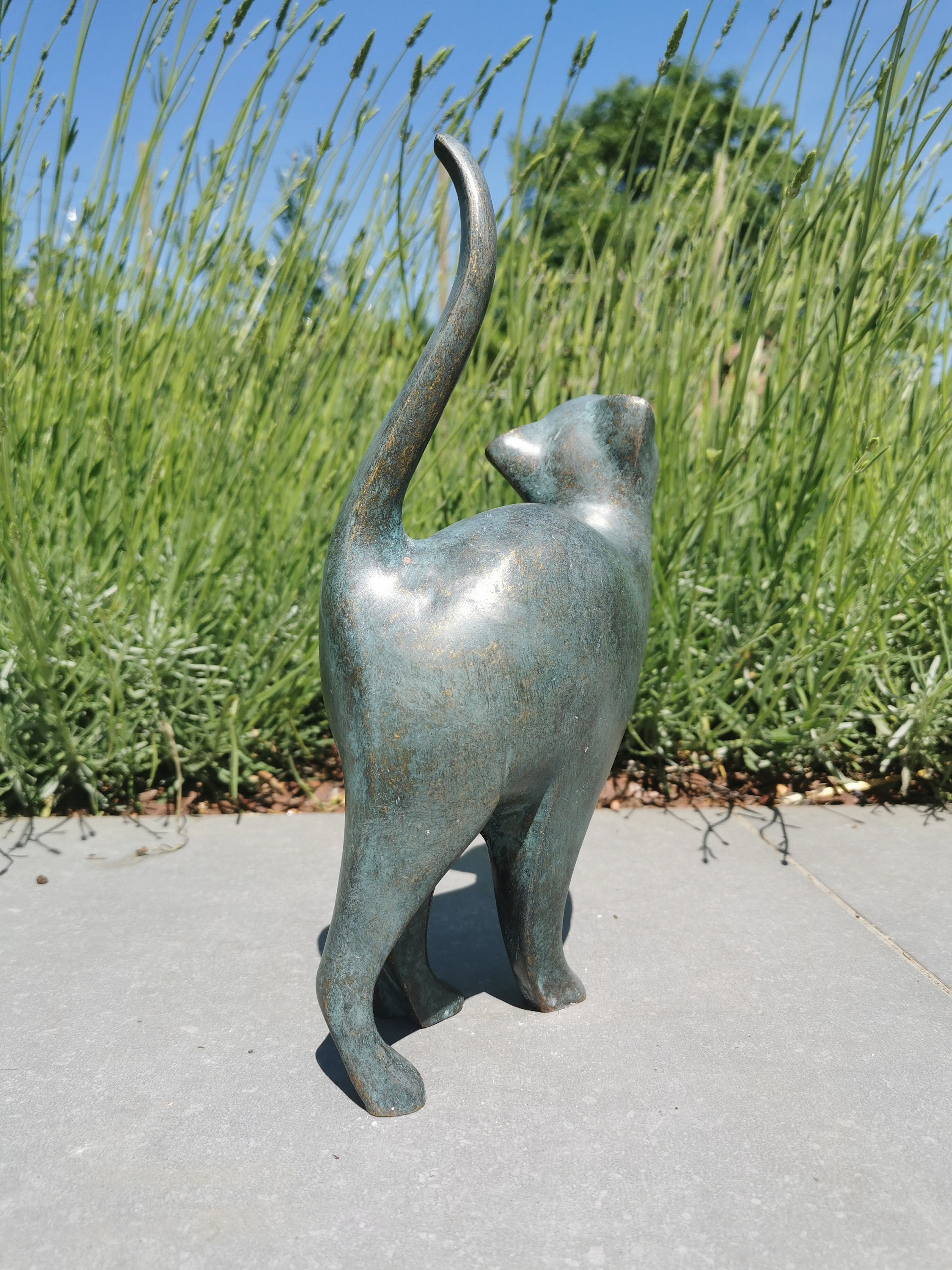 Beautiful bronze sculpture of a cat with a rounded back Bronze garden