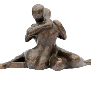 A bronze sculpture of an embracing couple