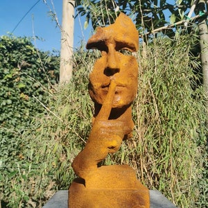 Garden sculpture of a man who asks for silence - The whispering man