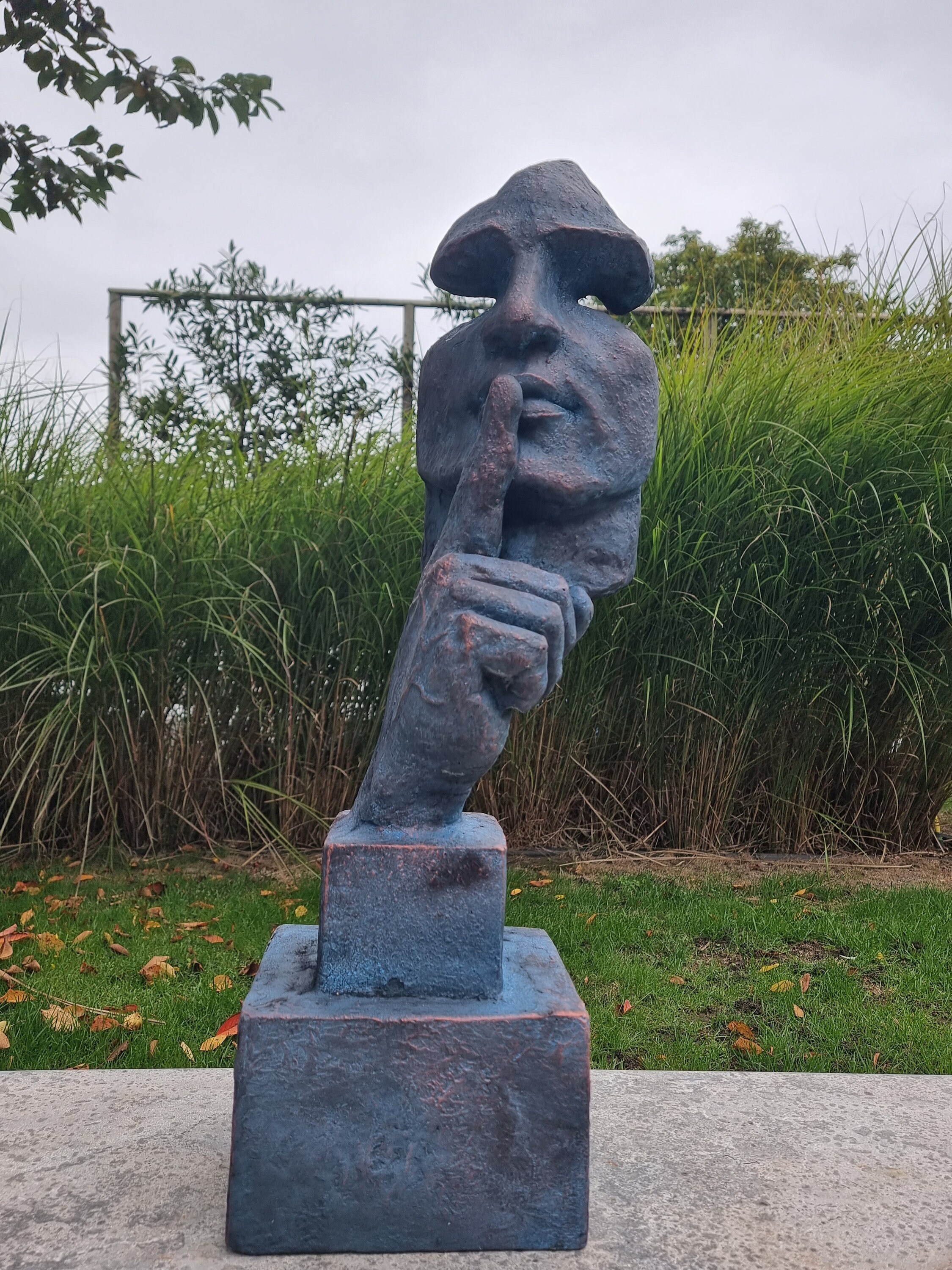 Large abstract sculpture of a male 'whispering' garden art