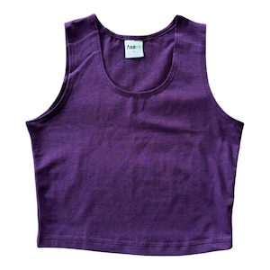 May include: A solid deep purple sleeveless crop top with a scoop neckline. The garment features a white interior neck label with the brand name Asatre printed in black text and the size S printed below it in a smaller font size.