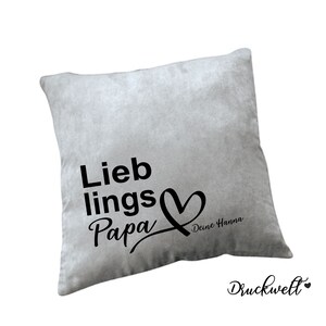 May include: Grey throw pillow with black text that reads "Lieblings Papa" with a heart and the text "Deine Hanna".