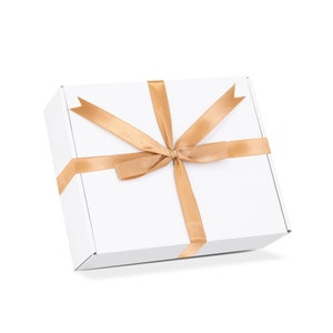 May include: A white gift box with a gold ribbon tied in a bow.