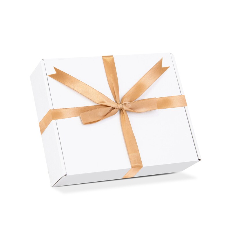May include: A white gift box with a gold ribbon tied in a bow.