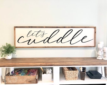 Let&#39;s Cuddle sign, above the bed sign