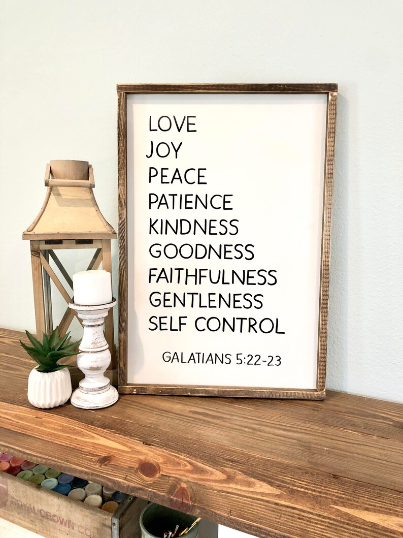 May include: A wooden sign with the text "LOVE, JOY, PEACE, PATIENCE, KINDNESS, GOODNESS, FAITHFULNESS, GENTLENESS, SELF CONTROL, GALATIANS 5:22-23" in black lettering.