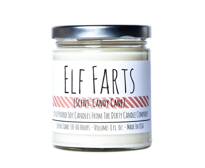 May include: A glass jar candle with a silver lid. The label reads "ELF FARTS (SCENT: CANDY CANE)" and "HAND POURED SOY CANDLES FROM THE DIRTY CANDLE COMPANY BURN TIME: 50-60 HOURS - VOLUME: 8 FL. OZ. - MADE IN USA".