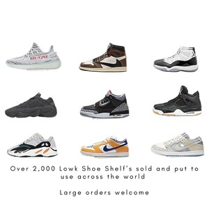 May include: Nine pairs of sneakers in various styles and colors, including white, black, grey, brown, and orange. The sneakers are arranged in three rows of three. The text "Over 2,000 Lowk Shoe Shelf's sold and put to use across the world" and "Large orders welcome" are at the bottom of the image.