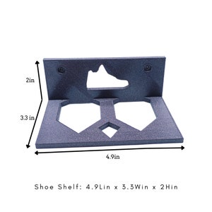 May include: A black shoe shelf with two slots for shoes. The shelf is 4.9 inches long, 3.3 inches wide, and 2 inches high.  Shoe Shelf: 4.9Lin x 3.3Win x 2Hin