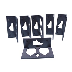 May include: Six black plastic shoe display stands with a shoe cutout. The stands are designed to hold sneakers.
