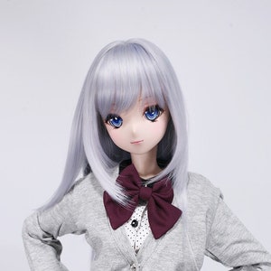 May include: A doll with long, straight, silver hair wearing a grey cardigan with a burgundy bow tie and a burgundy pleated skirt. The doll has blue eyes and a light pink complexion.