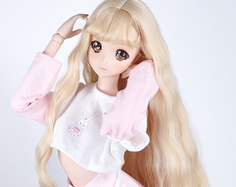 May include: A doll with long blonde hair wearing a pink and white crop top with a bunny design and a pink pleated skirt with a white belt.
