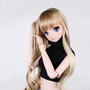 May include: A doll with long blonde hair wearing a black mock neck crop top and grey and black leopard print shorts.