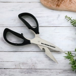 May include: Black kitchen shears with a bottle opener and a serrated blade. The shears are labelled "Bev's Kitchen Scissors".