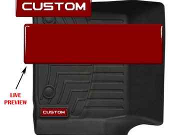 May include: A black floor mat with a custom logo and the text "CUSTOM" printed on it. The mat is made by TufSkinz Manufacturing.