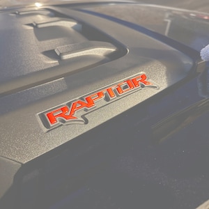 Tufskinz | Hood Cowling Emblem Inserts - Fits 2021-2025 F-150/Bronco Raptor - Sold as a pair
