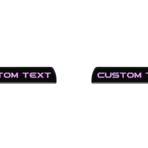 May include: Two black rectangular car decals with rounded corners. The decals have the text "CUSTOM TEXT" in pink.