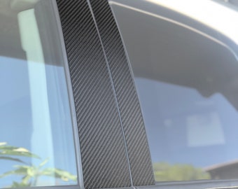 Puede incluir: Primer plano de una puerta de coche con tres piezas de moldura de ventana de fibra de carbono negra instaladas. Las piezas de moldura están hechas de fibra de carbono real y tienen un acabado en bruto. El texto "COLOR: REAL CARBON FIBER (RAW)" es visible en la parte superior de la imagen. El texto "TUFSKINZ MANUFACTURING" es visible en la parte inferior de la imagen.
