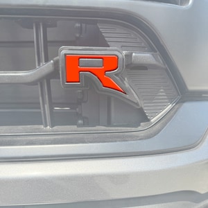 Tufskinz | Raptor "R" Grille Emblem Insert - Fits 2022-2025 F-150 Raptor - 1 Piece Kit