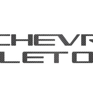 May include: A black and white carbon fiber decal with the text "CHEVROLET" in a bold, sans-serif font.