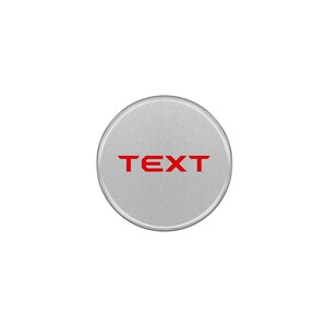 May include: A silver round button with the word "TEXT" in red lettering.