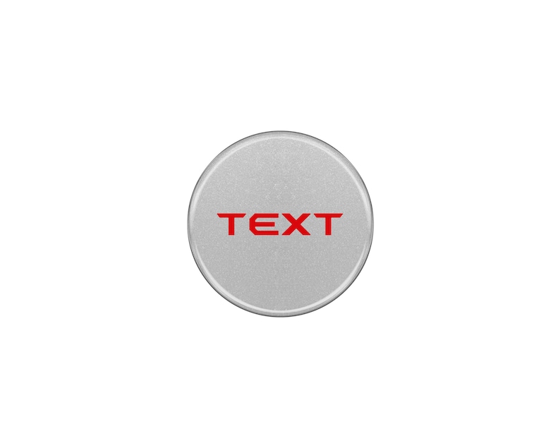 May include: A silver round button with the word "TEXT" in red lettering.