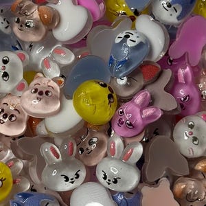 May include: Assortment of colorful resin flatback cabochons with various animal and heart designs. The cabochons are perfect for crafting projects like jewelry making, scrapbooking, and resin art.