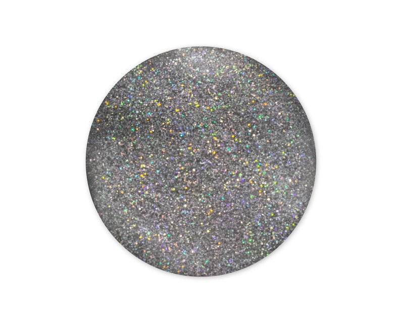 May include: A round silver glitter nail polish with a holographic finish.