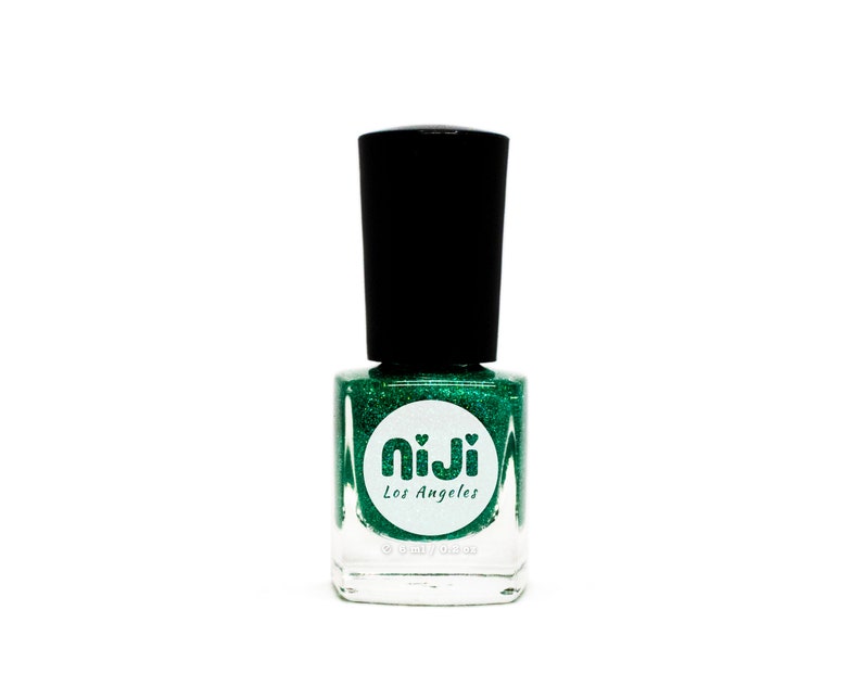 May include: A bottle of green glitter nail polish with a white label that says "niji Los Angeles".
