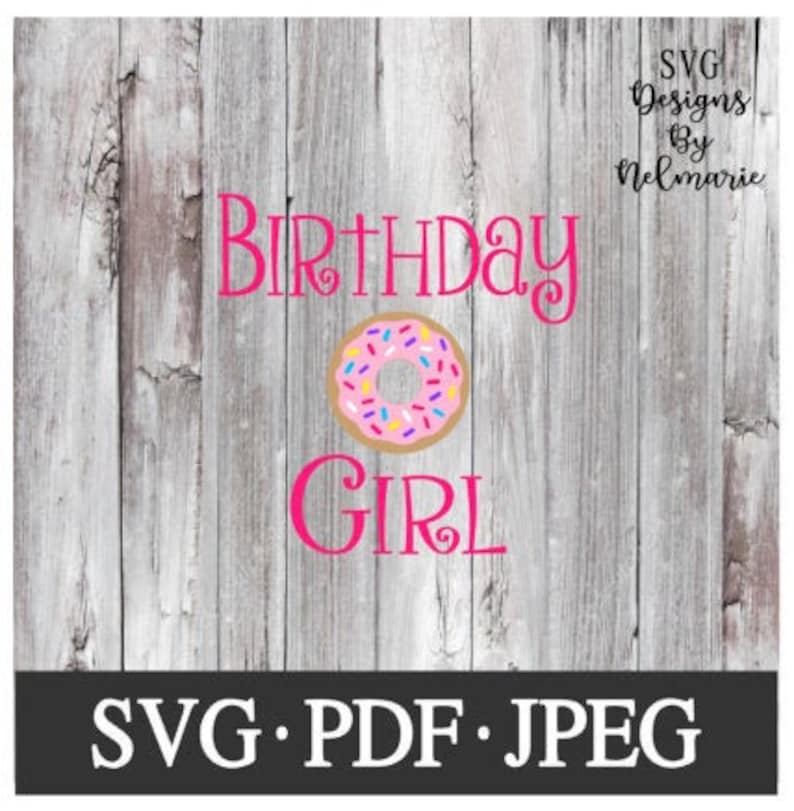 May include: Pink and white donut with sprinkles on a woodgrain background. The text "Birthday Girl" is in pink letters.