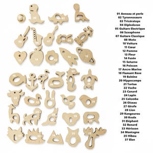 May include: A collection of 37 wooden cutouts in various shapes, including animals, musical instruments, and geometric forms. The shapes are unpainted and feature a natural wood grain. Each cutout has a number next to it.